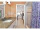 Bright bathroom featuring a granite countertop, shower, and open view to the kitchen at 4876 253Rd E St, Myakka City, FL 34251