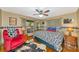 Rustic bedroom featuring hardwood floors, cow print accents, and a comfortable red recliner at 4876 253Rd E St, Myakka City, FL 34251