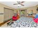Rustic bedroom featuring hardwood floors, plaid curtains, and a comfortable red recliner at 4876 253Rd E St, Myakka City, FL 34251