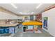 A well-lit room with a ceiling fan, white cabinets, and tables for various projects at 4876 253Rd E St, Myakka City, FL 34251