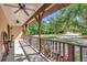 Covered porch with ceiling fans, decorative wagon wheel, and a beautiful view of the yard at 4876 253Rd E St, Myakka City, FL 34251