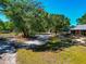 Picturesque property featuring mature trees, a barn, and a home with a covered porch at 4876 253Rd E St, Myakka City, FL 34251