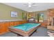 Game room featuring a pool table, wood paneling, and a stone fireplace at 4876 253Rd E St, Myakka City, FL 34251
