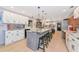 A sprawling, open kitchen with a large island, white cabinets, and modern lighting fixtures at 4876 253Rd E St, Myakka City, FL 34251