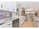 Bright kitchen with white cabinets, granite countertops, stainless steel appliances and tile floor at 4876 253Rd E St, Myakka City, FL 34251