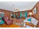 Cozy living room with wood floors, a rustic rug, and comfortable seating arrangement at 4876 253Rd E St, Myakka City, FL 34251