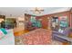 Warm living room with wood floors, a stylish rug, and views into the adjacent dining room at 4876 253Rd E St, Myakka City, FL 34251