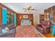 Comfortable living room with rustic accents, bright curtains, and traditional rug at 4876 253Rd E St, Myakka City, FL 34251