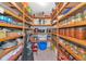 Organized pantry with wooden shelving, filled with an assortment of food and kitchen supplies at 4876 253Rd E St, Myakka City, FL 34251