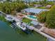 Aerial view showcasing a home with a private pool, boat dock, and waterfront access, ideal for boating enthusiasts at 519 74Th St, Holmes Beach, FL 34217