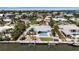 Aerial view of the coastal home, showcasing its dock, backyard pool, and neighborhood at 519 74Th St, Holmes Beach, FL 34217