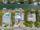 Aerial view showcasing a home with a private pool, boat dock, and waterfront access, ideal for boating enthusiasts at 519 74Th St, Holmes Beach, FL 34217