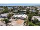 Aerial view of a waterfront home with lush greenery, dock, and access to the bay at 519 74Th St, Holmes Beach, FL 34217