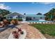 Inviting backyard featuring a pool, spa, patio with fire pit, and lush landscaping at 519 74Th St, Holmes Beach, FL 34217