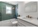 Bathroom showcasing tiled shower over tub, brushed gold fixtures and neutral vanity at 519 74Th St, Holmes Beach, FL 34217