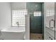 This bathroom showcases a modern tub with a separate shower featuring elegant blue tile at 519 74Th St, Holmes Beach, FL 34217