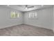 Bright bedroom boasts two windows with shutters, neutral walls, and modern floors at 519 74Th St, Holmes Beach, FL 34217