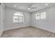This bright bedroom features modern paneling, an arched window, and light wood-look floors at 519 74Th St, Holmes Beach, FL 34217
