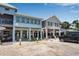 Charming shop front exteriors featuring coastal architecture with covered seating areas and storefront windows at 519 74Th St, Holmes Beach, FL 34217