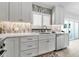 Bright kitchen featuring white cabinets and countertops, stainless steel appliances, and unique backsplash and shuttered window at 519 74Th St, Holmes Beach, FL 34217