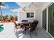 Outdoor patio seating area featuring a round table with seating for four and a ceiling fan at 519 74Th St, Holmes Beach, FL 34217