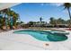 Backyard pool and spa with tropical landscaping, lush grass and boat dockage beyond at 519 74Th St, Holmes Beach, FL 34217