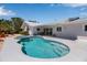 Rear exterior view featuring a pool, spa, patio, lush landscaping and boat dockage at 519 74Th St, Holmes Beach, FL 34217