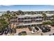 Attractive building with outdoor seating and mature landscaping, surrounded by convenient parking spaces at 519 74Th St, Holmes Beach, FL 34217