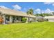 Spacious backyard featuring a well-kept lawn, enclosed patios, and attractive landscaping, perfect for outdoor enjoyment at 5448 Crestlake Blvd # 158, Sarasota, FL 34233