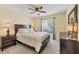 Bedroom with dark wood furnishings and a window bringing in ample natural light at 5448 Crestlake Blvd # 158, Sarasota, FL 34233