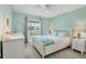 Light-filled bedroom with a white wood bed frame, white dressers and a view of the yard at 5448 Crestlake Blvd # 158, Sarasota, FL 34233