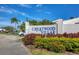 Welcome to Crestwood Villas! A community sign amidst lush landscaping under a bright, blue sky at 5448 Crestlake Blvd # 158, Sarasota, FL 34233