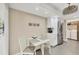 A white kitchen table with chairs and a stainless refrigerator at 5448 Crestlake Blvd # 158, Sarasota, FL 34233