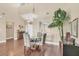 Dining area with hardwood flooring, glass table, and large windows at 5448 Crestlake Blvd # 158, Sarasota, FL 34233