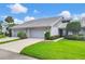 Lovely home with tidy landscaping, featuring mature trees and an attached two-car garage at 5448 Crestlake Blvd # 158, Sarasota, FL 34233