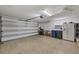 Spacious garage with a fridge, recycling and garbage bins, and a wall mounted barbecue at 5448 Crestlake Blvd # 158, Sarasota, FL 34233