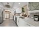 A kitchen featuring stainless appliances, light countertops, mosaic backsplash, and a view of the living area at 5448 Crestlake Blvd # 158, Sarasota, FL 34233