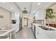 Bright kitchen features modern stainless appliances, sleek white cabinetry and mosaic tile backsplash at 5448 Crestlake Blvd # 158, Sarasota, FL 34233
