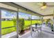 Relaxing screened lanai with a table, chairs, and a lush green lawn view at 5448 Crestlake Blvd # 158, Sarasota, FL 34233
