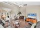 Open floor plan with hardwood floors, ceiling fan, and modern entertainment center with TV screen at 5448 Crestlake Blvd # 158, Sarasota, FL 34233