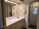Bright bathroom features a large mirror, vanity with cabinets, and tile floors at 5536 Denmark Dr, Bradenton, FL 34207