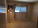 Neutral bedroom with a window dressed with curtains and a floor lamp at 5536 Denmark Dr, Bradenton, FL 34207