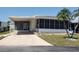Charming single-story home featuring a screened-in porch, mature landscaping, and a cozy curb appeal at 5536 Denmark Dr, Bradenton, FL 34207