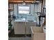 Practical laundry area featuring washer, dryer, utility sink, and shelving at 5536 Denmark Dr, Bradenton, FL 34207