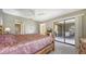 Bright bedroom featuring access to outdoor patio through sliding glass doors at 5649 Summerside Ln # 41B, Sarasota, FL 34231