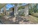 Two-story condo with a large tree, stairs leading to entrance, and neutral-colored facade at 5649 Summerside Ln # 41B, Sarasota, FL 34231