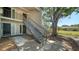 Condo exterior with stairs to the second floor and mature landscaping surrounding the building at 5649 Summerside Ln # 41B, Sarasota, FL 34231