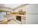 Kitchen with ample white cabinets, white appliances, and tile floors at 5649 Summerside Ln # 41B, Sarasota, FL 34231