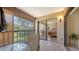 View from screened patio into bedroom featuring a bed, dresser, and tile flooring at 5649 Summerside Ln # 41B, Sarasota, FL 34231