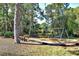 Community playground featuring swings, bench seating, and mature trees at 5649 Summerside Ln # 41B, Sarasota, FL 34231